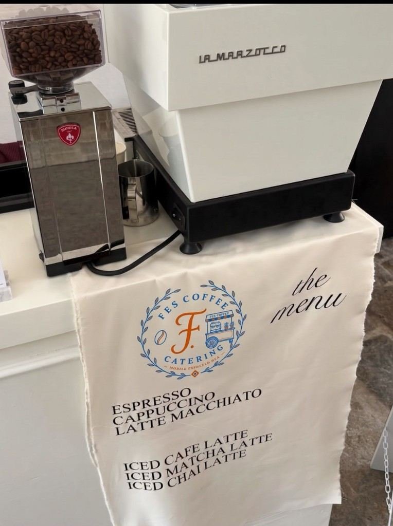 Fes Coffee Catering menu cloth beside a La Marzocco espresso machine