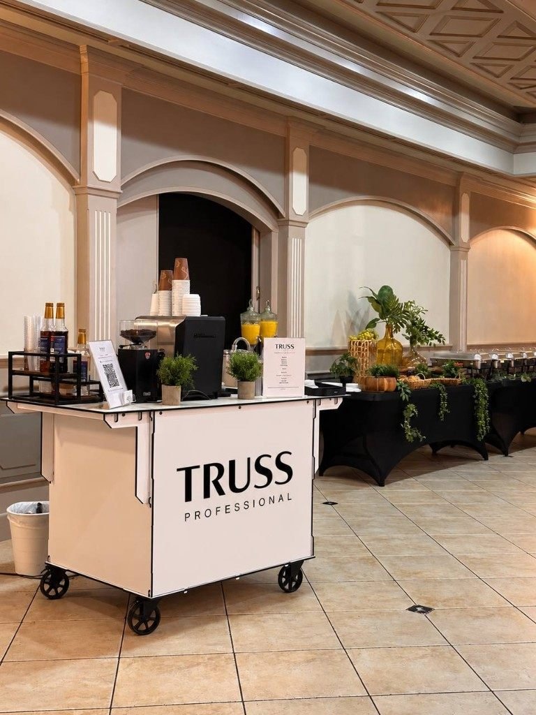 Fes Coffee cart branded for Truss Professional at an indoor event