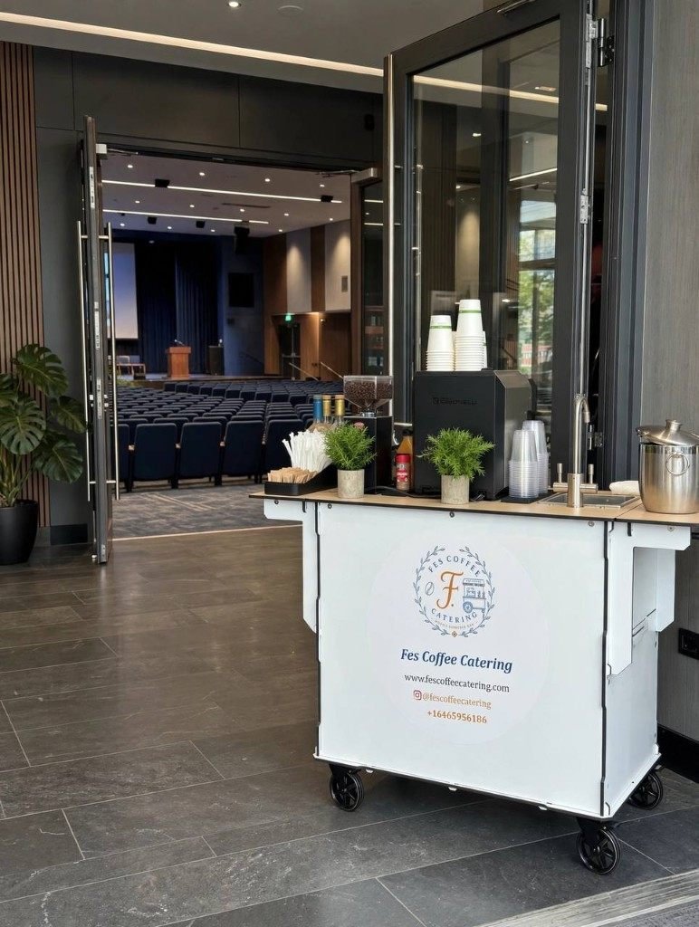 Fes Coffee cart beside an open conference auditorium