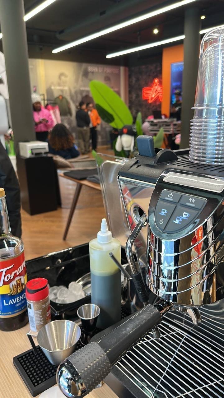 Espresso machine, syrup bottles and cups on the Fes Coffee cart at an in-store event