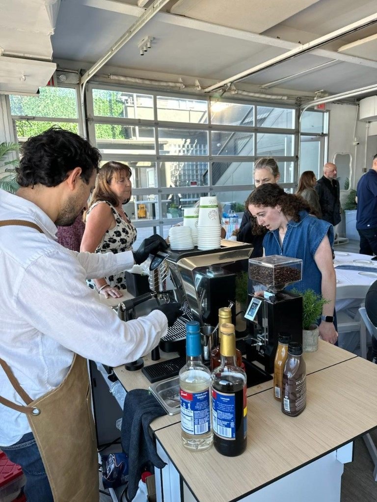 Barista serving guests at a Fes Coffee event