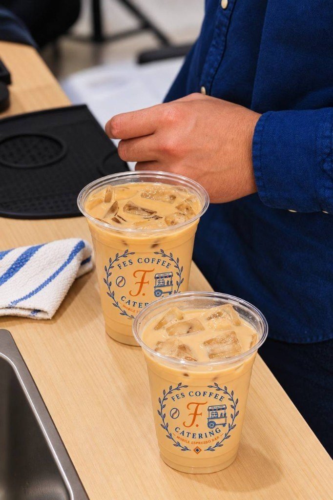 Two iced lattes in Fes Coffee branded cups