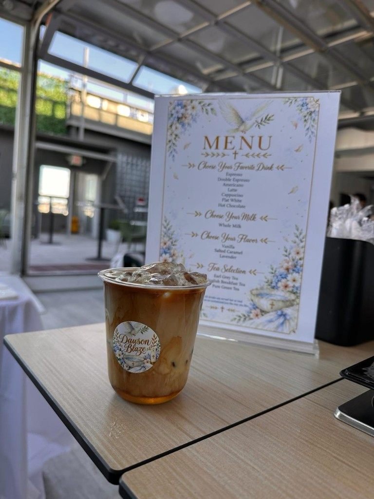 Iced latte beside a custom event menu